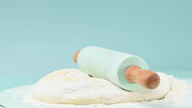 rolling pin and dough on a table