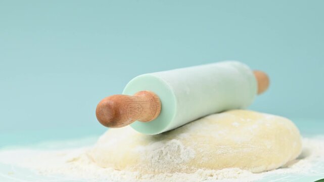 rolling pin and dough on a table