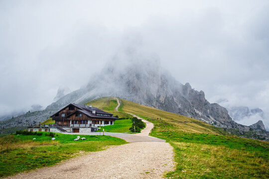 Foggy autumn evening alpine view from the top of Giau pass with famous Ra Gusela, Nuvolau peaks in the background,  Dolomite Alps, Cortina d`Ampezzo, Italy, Europe.
