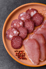 Obraz premium Smoked or dry cured salami slices or ham with salt and spices. Smoked sausage