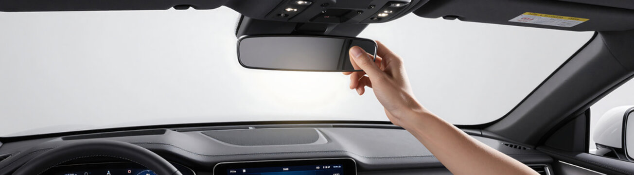gentle hand closes sun visor mirror sleek car dashboard extinguishing soft glow showcase sophisticated