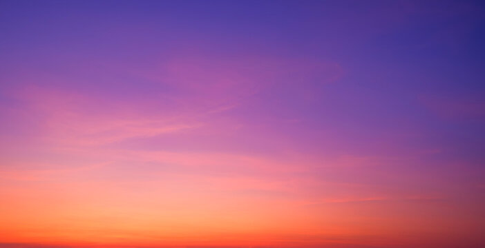 Twilight Sky Panoramic Background with Nature Gradient Light and Soft Pink Cloud on Colorful Orange and Blue Romantic Evening sky after Sundown
