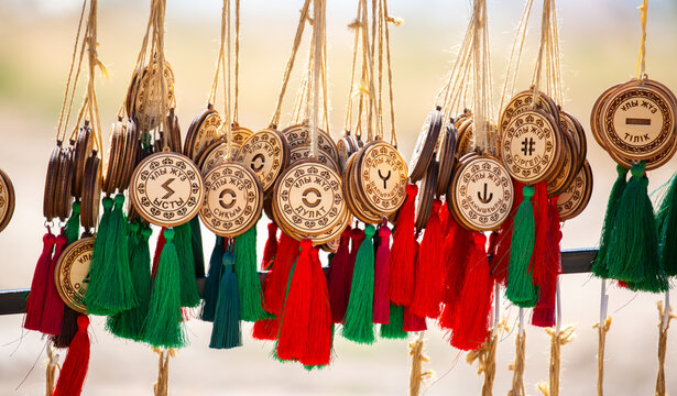 Kazakh national souvenirs, pendants with zhuz and clan names. Ethnic jewelry, handicrafts made of wood, reflecting the rich culture and traditions of Kazakhstan. Turkestan, Kazakhstan - June 30, 2024