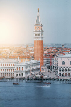 View of St Mark's Campanile and Doge's Palace overlooking the Grand Canal with boats in Venice, Veneto, Italy.