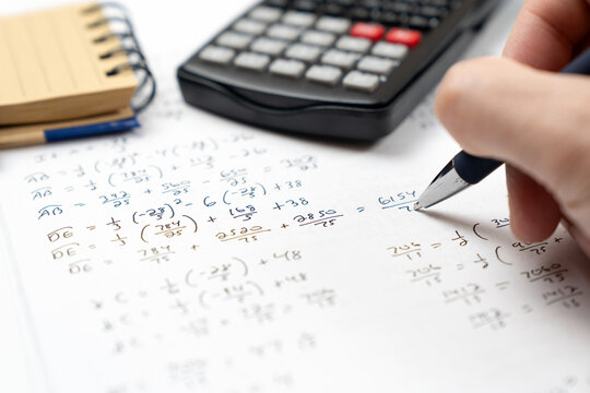 Mathematics geometry handwritten notes and circle diagrams paired with a scientific calculator and a ballpoint pen for college education