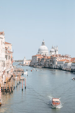 View of the Grand Canal with the Basilica di Santa Maria della Salute and motorboats on the water Venice, Veneto, Italy.
