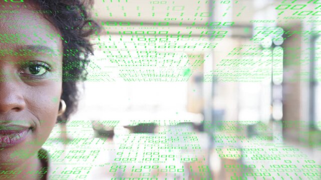 Woman holding gaze in office as green data overlay starting scrolling across face for analytics