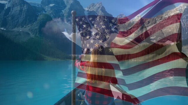 Travel woman rowing canoe on lake to peaks, paddle lift starting strokes as flag overlay obscuring