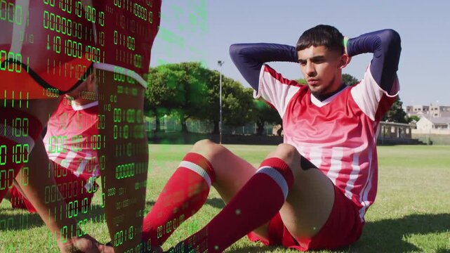 Soccer player doing situps while teammate holding feet, binary overlay hiding anchor during warmup