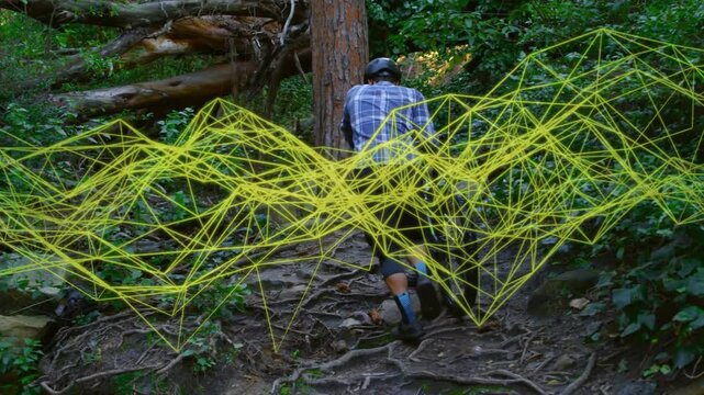 Man nearing rooty incline pushing bike uphill navigating roots for cycling, yellow net shifting