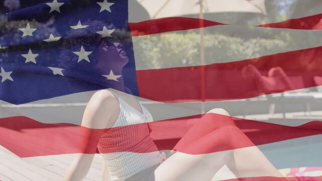 Woman shifting back on wood pool deck, sun drawing head up, US flag overlay waving, lifestyle