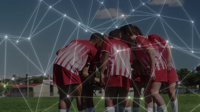 Soccer team huddling, talking and sparking network overlay, lifting ball overhead to rally team