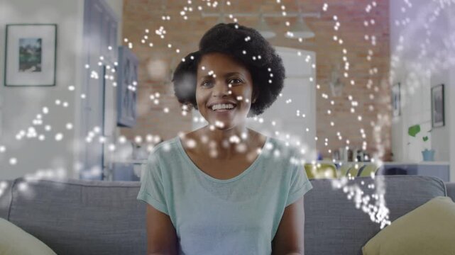 Woman sitting on sofa speaking and gesturing overlay appearing while speaking forming arcs for tech