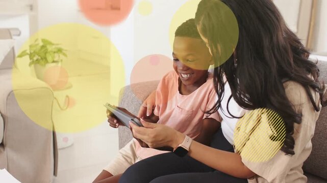 Child tapping tablet, mother guiding, animated bubbles growing then thinning, supporting education