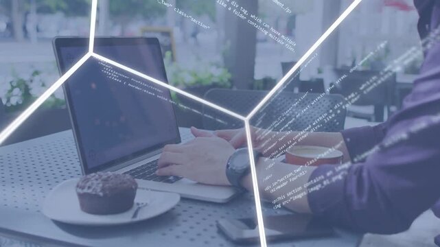 Man typing laptop at cafe, initiating rotating wireframe covering hands and screen while coding