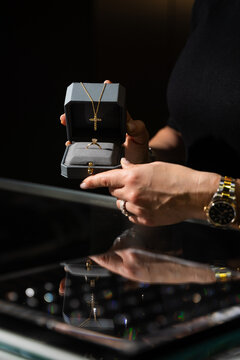 Jewelry box with ring and necklace in a luxury retail setting.