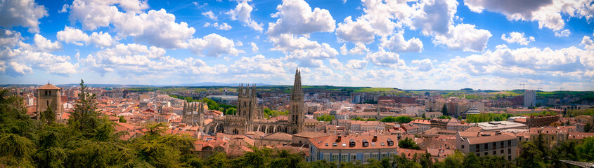 Fototapeta premium Burgos cathedral dominating the ancient cityscape under a blue sky with white clouds