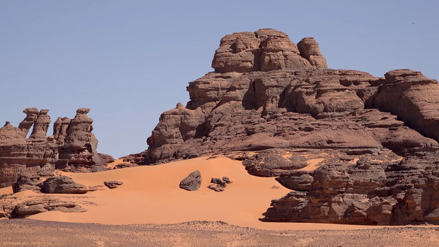 A trip to Sahara desert in Algeria. Beautiful 
african travel photo. Sandy landscapes, mountains, rocks,
dunes, and nature. Summer vacation in arab country.
