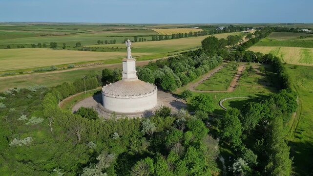Cinematic aerial drone shot of the Tropaeum Traiani victory monument built by Emperor Trajan. Ancient Roman architecture in Dobrogea region, Adamclisi, Romania.