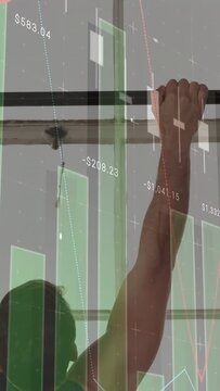 Vertical video: Man gripping bar and pulling up, training while finance graphics overlaying torso