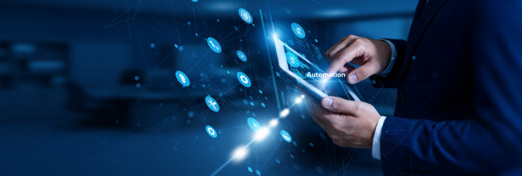Automation Engineer touching automation using tablet control network, robotics, process optimization, efficiency, smart systems.