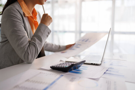 Businesswoman analyzing accounting data and financial charts