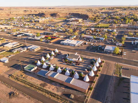 Holbrook, United States - 05 April 2026: Aerial view of the historic Wigwam Motel with its iconic teepee-shaped rooms along Route 66, surrounded by the desert landscape and urban layout of the town.