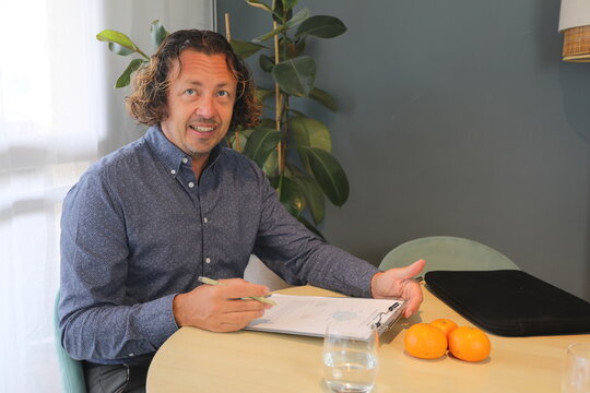 Man Reviewing Document at Table