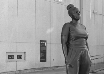 Fototapeta premium black and white view of a young black woman statue by Thomas J Price called 