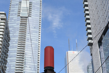 Naklejka premium remnant red can and buildings (left) west elevation of Shangri-La hotel and BMO Group sign at First Canadian Place, Toronto