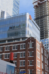 Obraz premium exterior of 19 Duncan, designed by Hariri Pontarini Architects - mixed-use integration of the heritage Southam Press Building and a modern 58-storey tower, housing Thomson Reuters offices