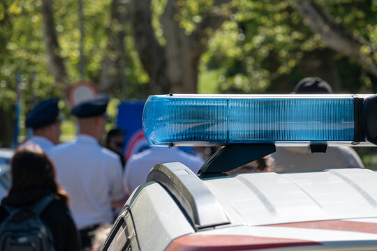 Police lightbar with officers blurred background