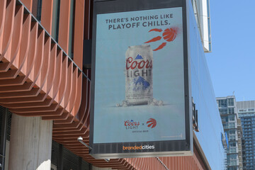 Naklejka premium LED advertising for Coors Light and NBA Toronto Raptors on the exterior of The Well, a mixed use complex at 486 Front St W, Toronto