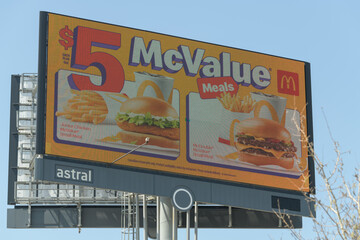 Naklejka premium roadside pylon sign featuring advertising for $5 McValue Meals, McDonald's Canada fast food restaurant chain, Toronto