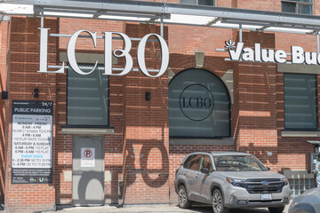 Naklejka premium suspended channel lettering signs at LCBO liquor store chain and Value Buds cannabis store located at 49 Spadina Av (parking area), Toronto