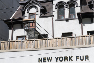 Naklejka premium sign outside NEW YORK FUR located inside a heritage property known as H.S. Strathy House, built 1858, in Second Empire style, at 342 Adelaide St W, Toronto