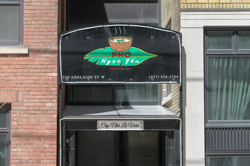 Fototapeta premium exterior building and sign of Pho Ngoc Yen 3, a Vietnamese restaurant, located at 350 Adelaide St W, Toronto