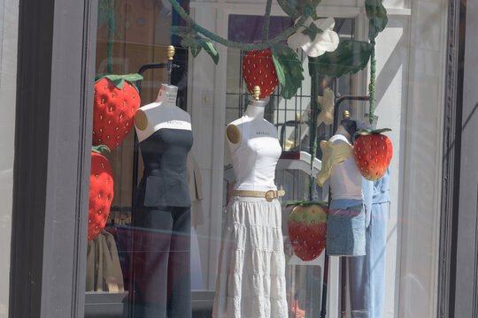 dressmaker forms with merchandise inside display windows at Aritzia, a women's clothing store, located here at 280 Queen St W, Toronto