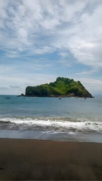 Remote Tropical Island and Small Traditional Boats under Cloudy Sky, Seascape View