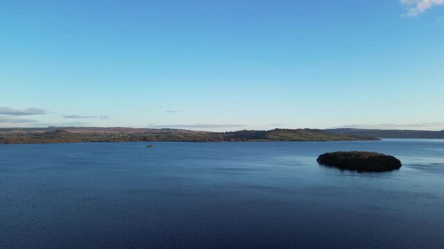 Aerial View of Calm Water of Massive Lake at Balmaha Valley Village Near Glasgow Landscape During Sunset. Village is a popular tourist destination for picnickers and day trippers from Glasgow