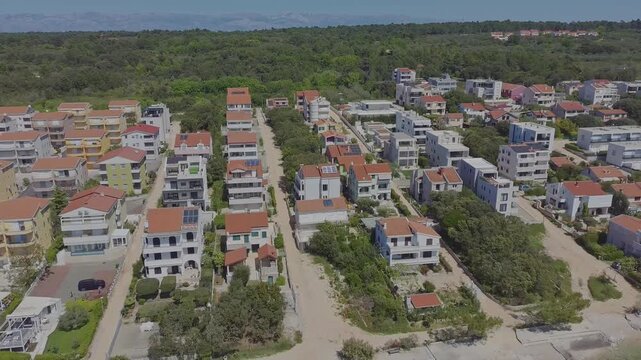 Aerial drone view of Kozino town in Croatia with beach modern tourist apartment buildings.