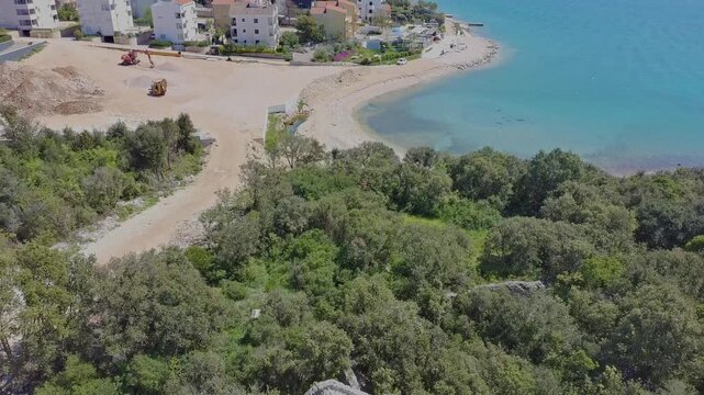 Aerial drone view of Kozino town in Croatia with beach modern tourist apartment buildings.