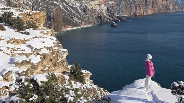 Snowy Ocean Cliffside, Beautiful Woman Posing, Winter Coastal Landscape Aerial