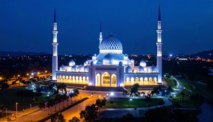 Fototapeta premium A large mosque lit up at night.