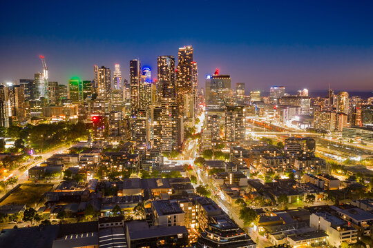 Aerial view of bright lights of a city skyline and surrounding suburbs at twilight