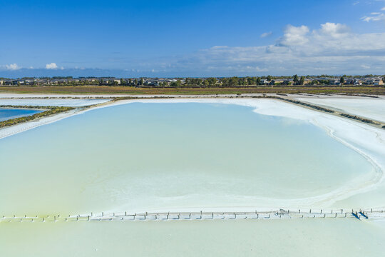 Aerial view of clouds reflected in a colourful coastal salt lake