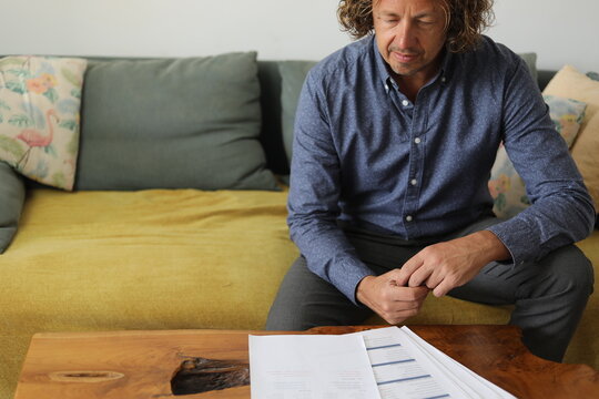 Man Reviewing Documents on Couch