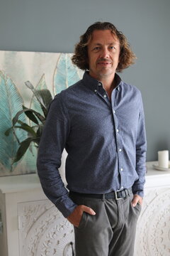 Man in Blue Shirt and Grey Trousers