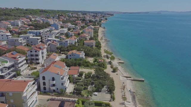 Aerial drone view of Kozino town in Croatia with beach modern tourist apartment buildings.