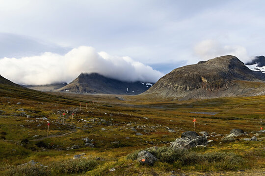 Sylarna mountain range with dramatic clouds rolling over the autumnal landscape. 